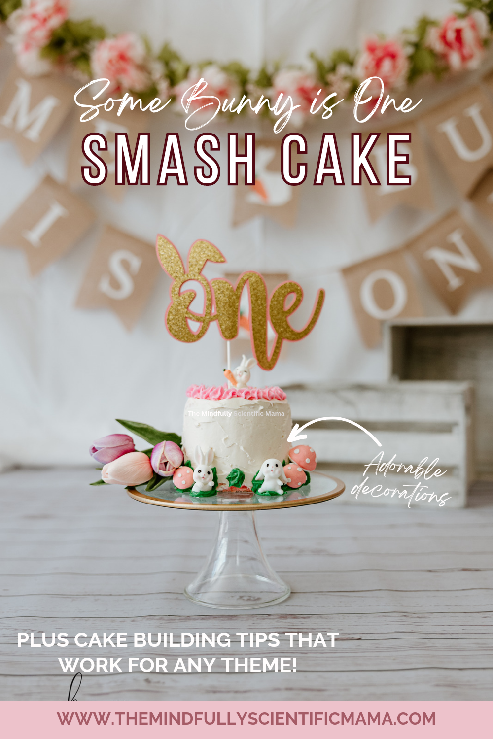 This image is for Pinterest. It depicts the white smash cake with bunny and flower decorations against the white, floral, and banner backdrop and the white floor. The text reads 